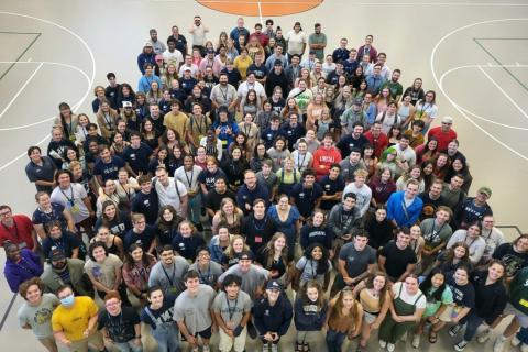 Group photo of RAs and CAs on gym court.