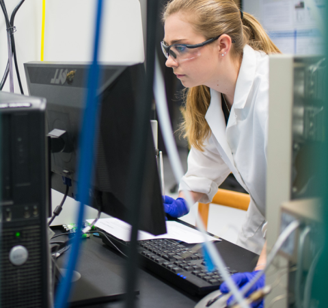 UNH student using a computer in a science lab